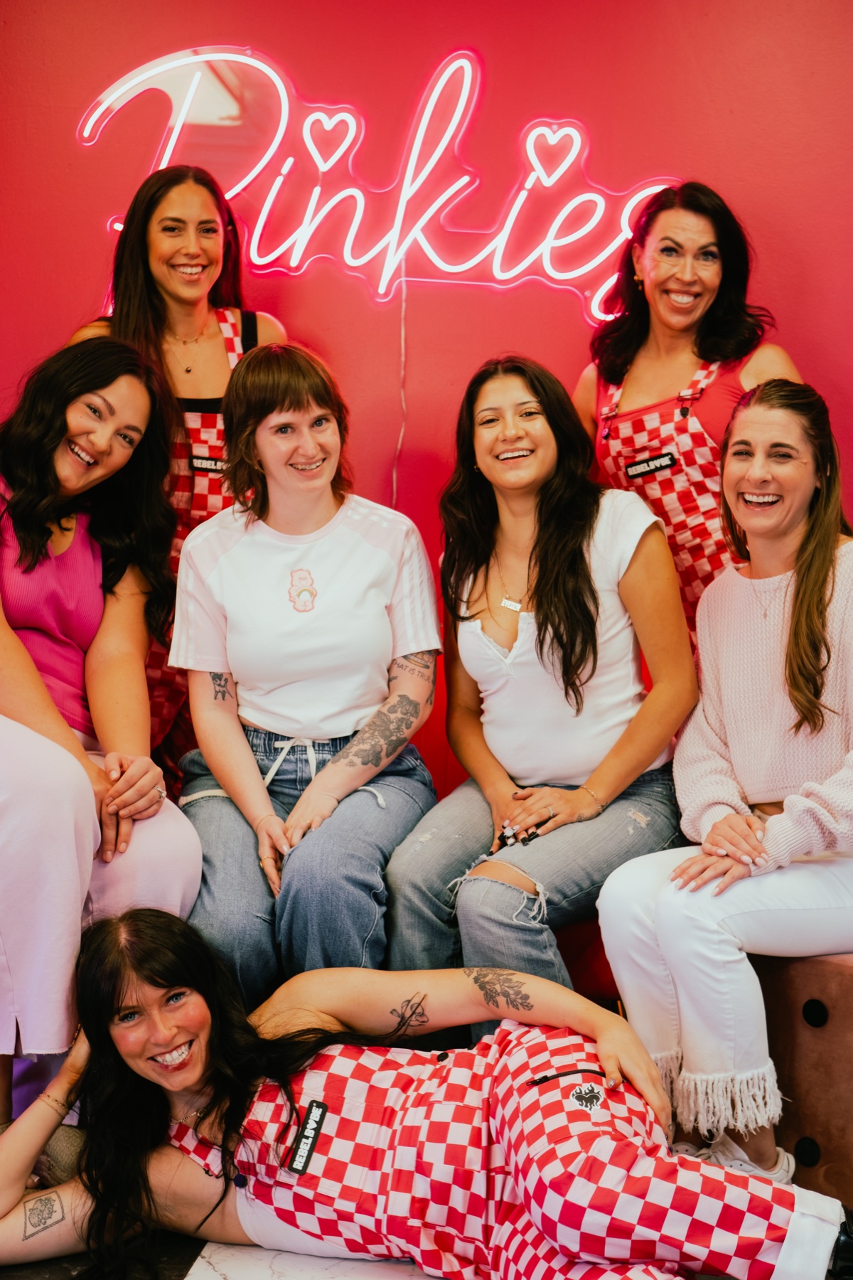 The Pinkies Beauty Bar team laughing together in the studio
